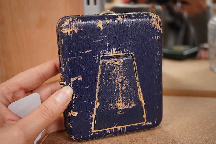 A leather travelling watch case, with nickel case goliath pocket watch, retailed by Asprey, with Roman dial and subsidiary seconds, case diameter 67mm.